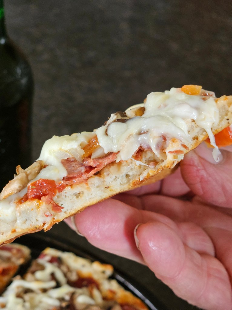 slice of gluten free pizza crust showing the texture